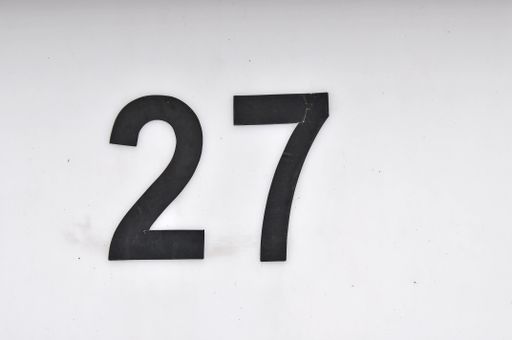 A closeup shot of the number twenty seven sign on a white background