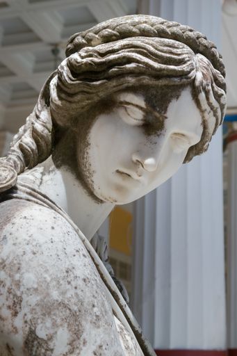 A vertical closeup shot of a Greek goddess statue in Corfu, Greece