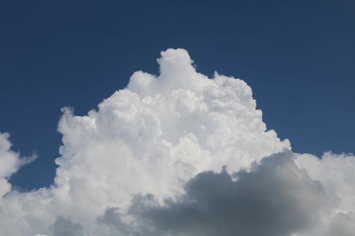 A beautiful low angle shot of large cumulative clouds in the sky during a gloomy day