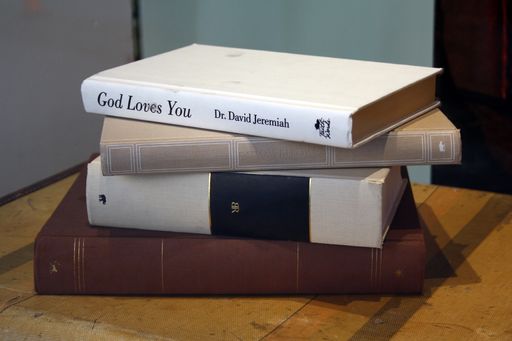 A stack of old books in the shopwindow in downtown Vancouver, British Columbia, Canada
