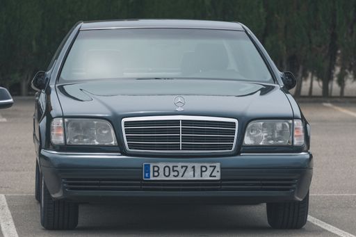 A classic luxury car parked in the park, Mercedes Benz W140