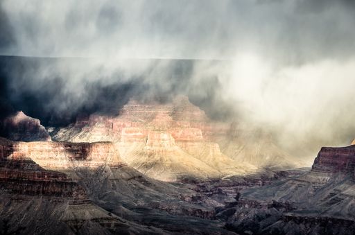 The beautiful Grand Canyon rock formations getting enveloped in natural fog and mist