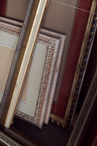 A vertical closeup shot of a lot of different wooden photo frames
