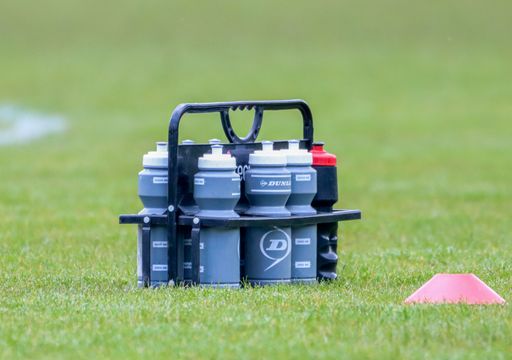 A bunch of sports water bottles at a football match