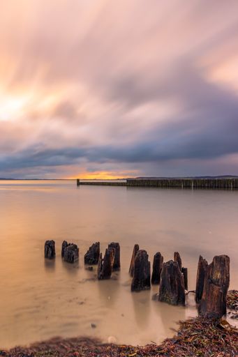 Vertical shot of sunrise over the coast of the Baltic Sea in Schleswig-Holstein, Germany