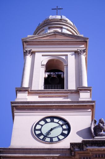 A low angle vertical shot of the bell tower of the Montevideo Metropolitan Cathedral under the clear blue sky in Montevideo Uruguay