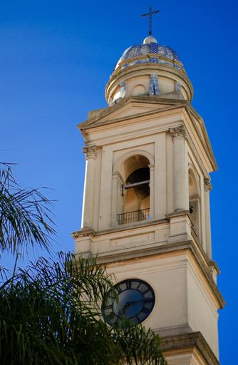 A low angle vertical shot of the bell tower of the Montevideo Metropolitan Cathedral under the clear blue sky in Montevideo Uruguay