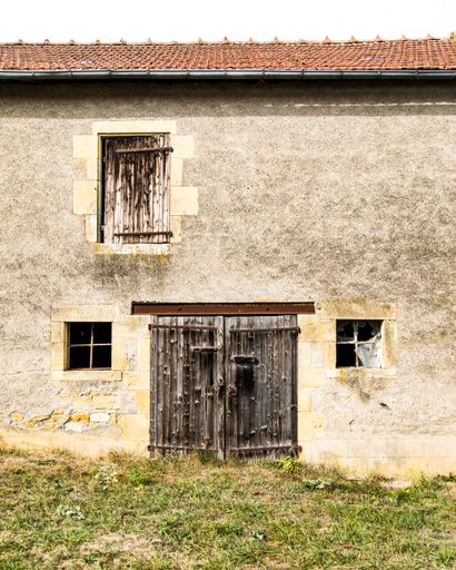 A vertical shot of an old beautiful cottage captured on a sunny day in the French Countryside