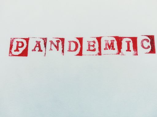 A high angle shot of a [PANDEMIC] writing on a white paper