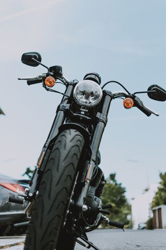 A vertical selective shot of a black and gray motorcycle