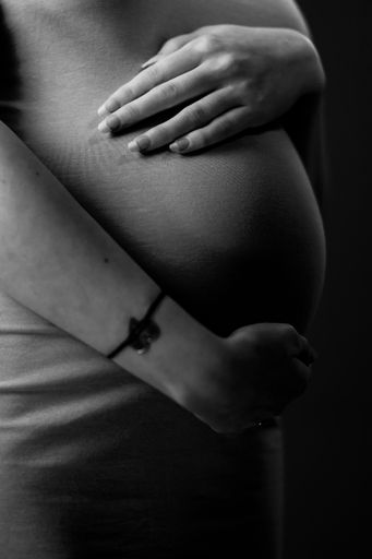 A pregnant woman holding her belly - 27 weeks
