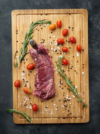 A top view of delicious flap meat on a wooden board