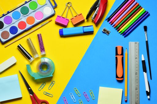 a top view shot of Zenith view  On yellow and blue bicolor background, various school supplies, education and learning.