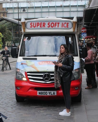 A female standing in front of ice cream truck in London