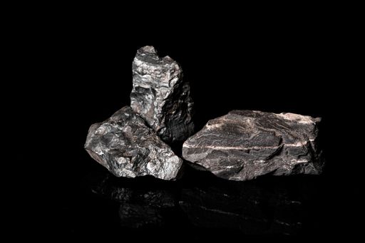 A closeup shot of raw material Manganese Ore rock isolated on black background