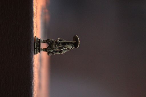 A vertical shot of an elephant figurine in the blurry background