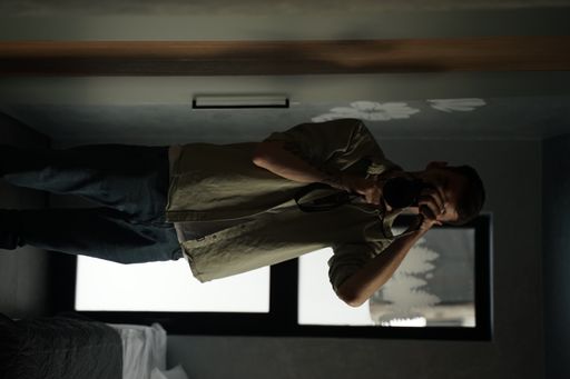 A closeup of a photographer taking a photo