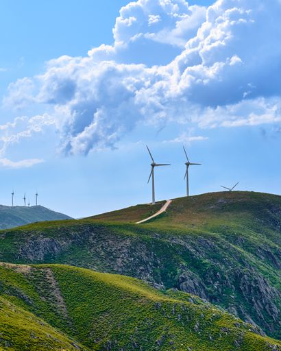 A beautiful landscape of a road near a field with wind turbines in Arouca, Portugal