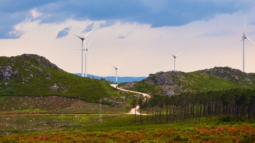 A beautiful landscape of a road near a field with wind turbines in Arouca, Portugal