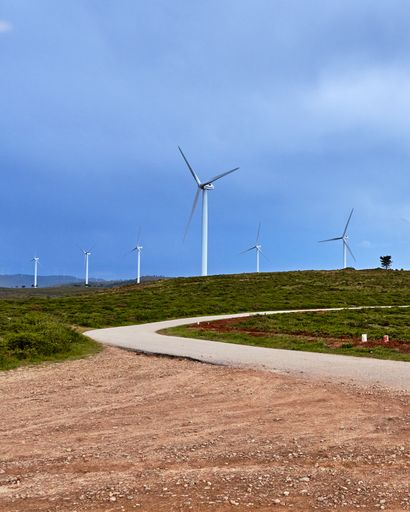 A beautiful landscape of a road near a field with wind turbines in Arouca, Portugal