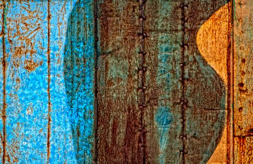 A view of an old wooden surface that can be a door or a wall painted into different colors