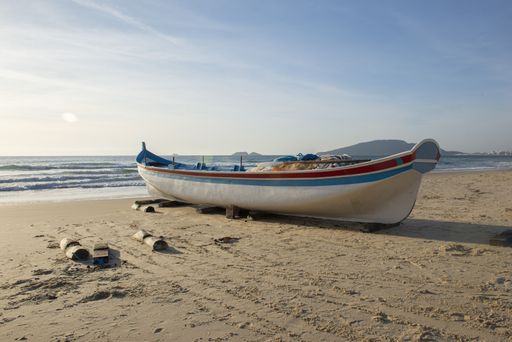 A boat parked at the Ingleses beach in Florianopolis, Brazil during the sunrise