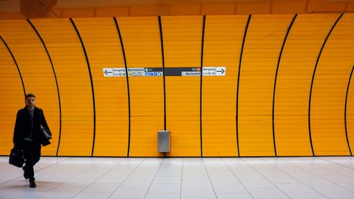 A beautiful shot of an adult Caucasian man walking in hurry in subway Berlin, Germany
