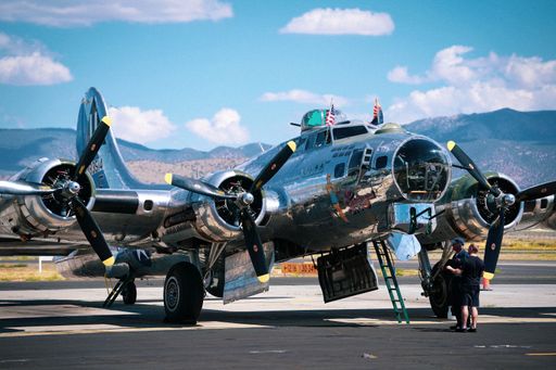 A low angle shot of a B-17 bomber plane from WWII captured on an airbase on a sunny day
