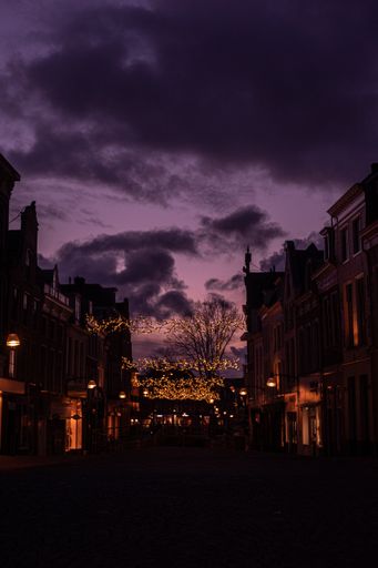A vertical shot of an empty street with lights during the night in Leeuwarden, the Netherlands