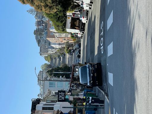 A vertical shot of the San Francisco cityscape and hills with cars