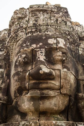 A vertical closeup shot of statue details on the Angkor Wat Temple in Cambodia