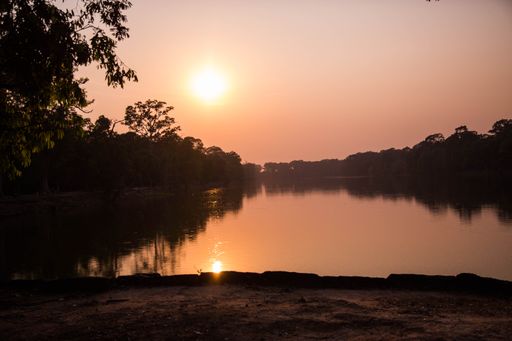 A beautiful sunset over a lake near the Angkor Wat temple in Cambodia