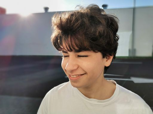A portrait of a teenage boy posing happily