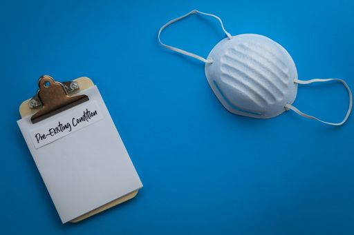 A doctor's prescription form next to a medical mask