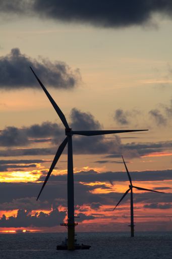 An amazing shot of wind turbines on a sunset background