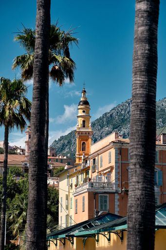 A beautiful shot of a small tower surrounded by a rural building on a nice sunny day in Cote d'Azur, France
