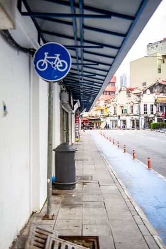 A vertical shot of a bicycle lane sign in the street