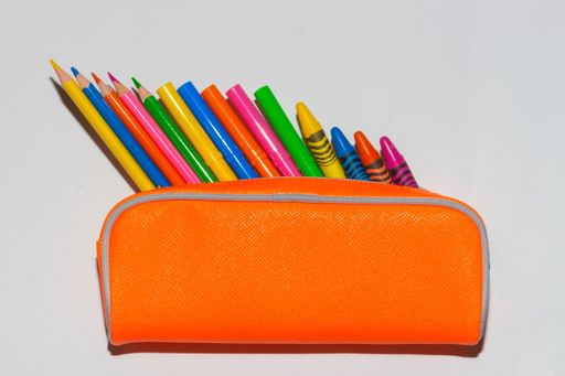A closeup shot of colored pencils on a pouch isolated on a white background