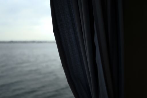 A black curtain with the beautiful sea in the background