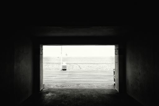 A greyscale vertical shot of an arch during daytime