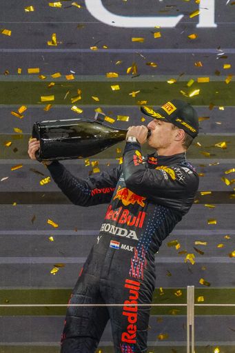 The famous Max Verstappen drinking champagne while celebrating his victory at Formula 1 Grand Prix, Abu Dhabi Final 2021, UAE