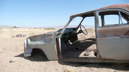 An old abandoned cur skeleton in a desert