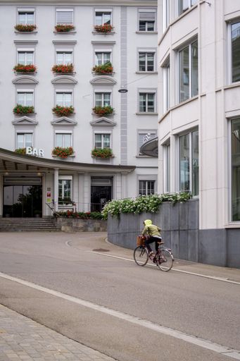A vertical shot of a cyclist on the street of  Saint Gallen