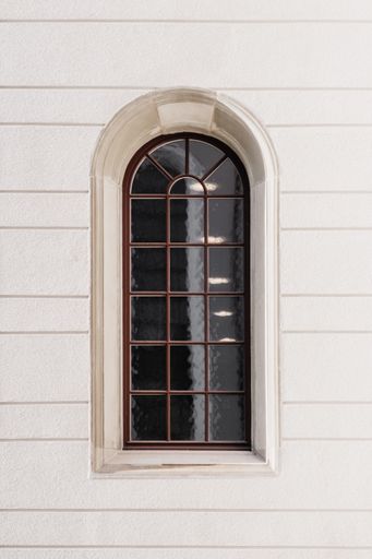 A vertical shot of a window on a white stone building in St.Gallen, Switzerland