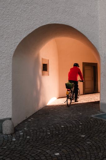 A vertical shot of a cyclist on the street of Saint Gallen