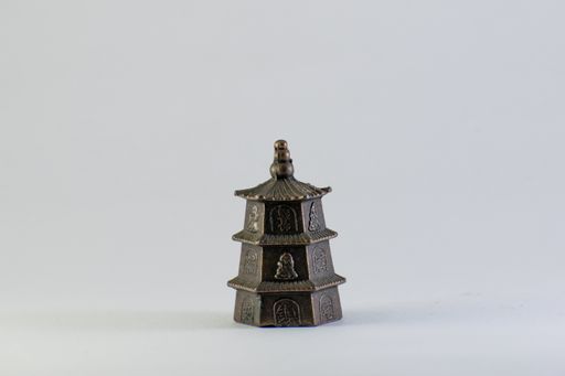 A Mini Tibetan sothon isolated against a white background