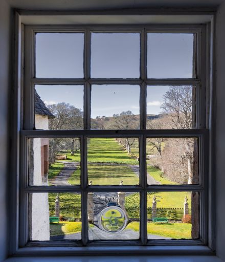 A view from an upstairs window of the Jacobite Traquair House in winter, looking down on the avenue of trees where Bonnie Prince Charlie once walked