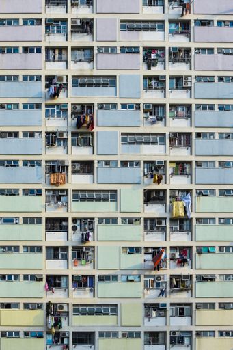 A beautiful shot of a residential building with rainbow colors on a sunny day. symmetric architecture of Choi Hung, Hong Kong