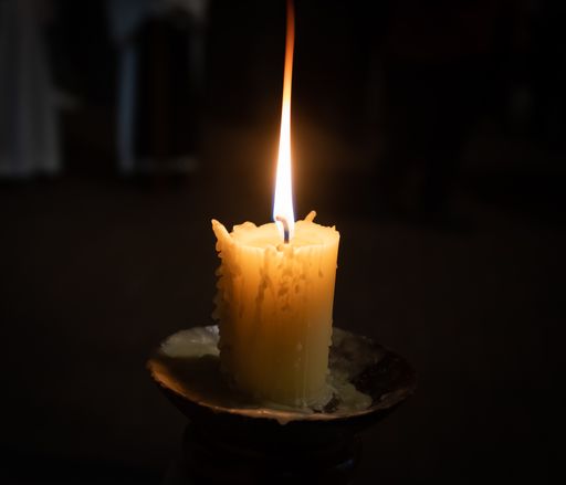 A closeup shot of a lighted candle from holy Wednesday processions in the holy week in the Spanish city of Valladolid