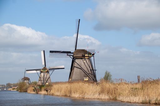 A closeup shot of windmills at the Dutch Heritage site in Kinderdijk, Netherlands in the summer